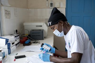 Lab Technician J. Valentine Poka conducts a urine dipstick test at Edith Wallace Health Center.