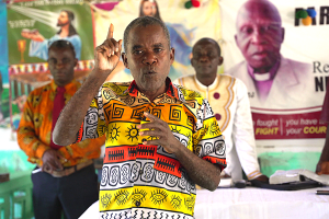 Anthony Toe, who receives mental health support from Partners In health, preaches at his church outside Harper 