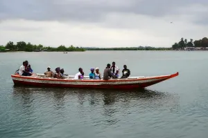 Residents of Puluken cross the Hoffman River on the Puluken Town Canoe