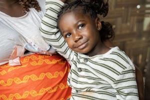 Dorcas Toe leans on her grandmother, Evelyn Jugbe, at their home in Pleebo, Maryland County, Liberia. 