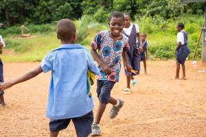 Dennis Toe (center) plays with his schoolmates during recess at the Dokliken Public School in Maryland County, Liberia. 