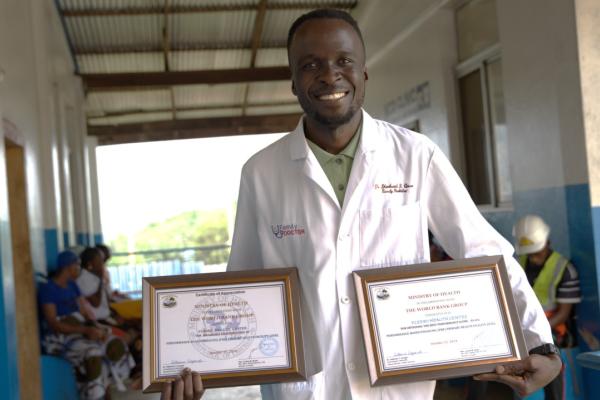 Dr. Gono displays certificates