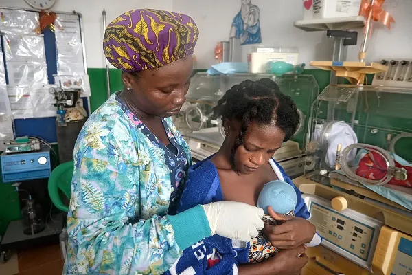 Mother holds baby in Liberia