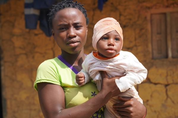 A young mother holding her child