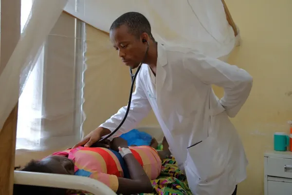 family medicine resident examines patient in Liberia