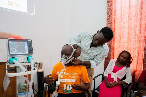 Roosevelt O. Yancy, nurse anesthetic from J.J Dossen Hospital, practices how to use the ventilator on Jean De Dieu Kaumba while Annette Tubman, CCN fellow, looks on.