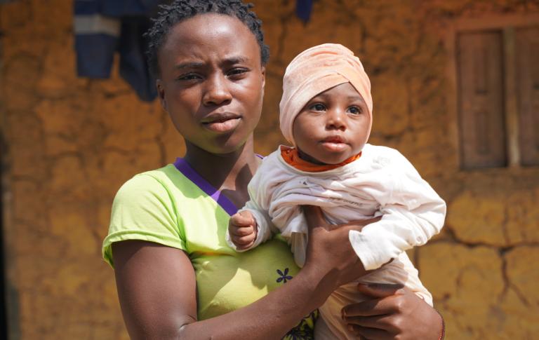 A community halth worker visits a former TB patient in Puluken, Liberia