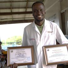 Dr. Gono displays certificates