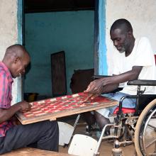 Two recovering NCD patients at JJ Dossen Hospital are playing a checker game.