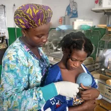 Mother holds baby in Liberia
