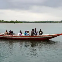 Residents of Puluken cross the Hoffman River on the Puluken Town Canoe
