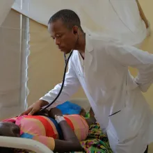 family medicine resident examines patient in Liberia