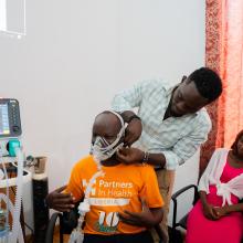 Roosevelt O. Yancy, nurse anesthetic from J.J Dossen Hospital, practices how to use the ventilator on Jean De Dieu Kaumba while Annette Tubman, CCN fellow, looks on.