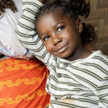 Dorcas Toe leans on her grandmother, Evelyn Jugbe, at their home in Pleebo, Maryland County, Liberia. 