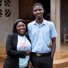Smiling Elizabeth Sackor hugs her son, Daniel Sackor