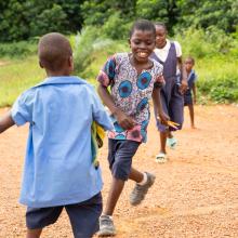 Dennis Toe (center) plays with his schoolmates during recess at the Dokliken Public School in Maryland County, Liberia. 