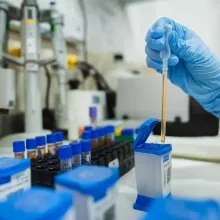 A sample is placed in a GeneXpert cartridge at a PIH-supported facility in Peru.