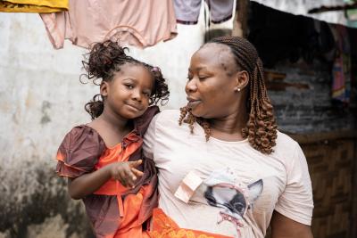 Dorcas' grandmother, Evelyn Jugbe, holds her in her arm at their home in Pleebo, Maryland County, Liberia