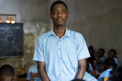 Daniel stands among his classmates in harper.